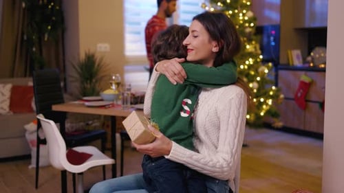 Loving Mother and Child Hugging on Christmas Day
