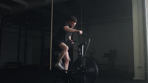 Athletic Man Exercising On Stationary Bike In Gym Professional Sportsman Keep Fit Active Workout