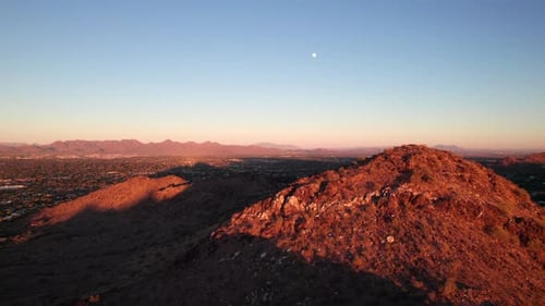 Long slow peaceful nature aerial clip. Arizona mountains and desert at dusk, ambient background shot