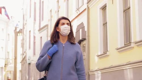 Woman Wearing Mask and Gloves Walking on City Street