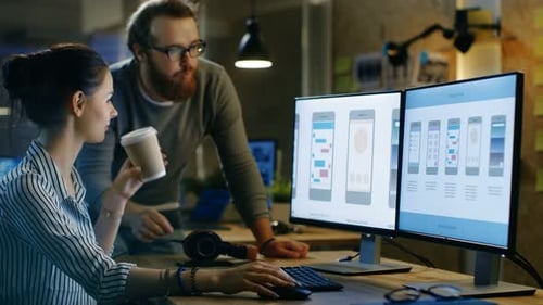 Female UX Architect Has Discussion with Male Design Engineer, They Work on Mobile Application Late