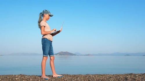 Watch on Laptop Against Sea