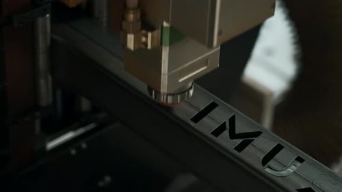 Laser cut head machine while cutting the sheet metal with the sparking light in factory