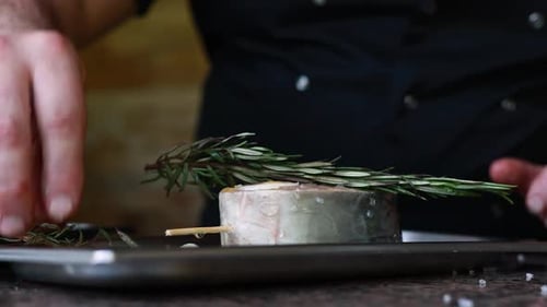 chef prepares a salmon dish in the kitchen. Close-up shots