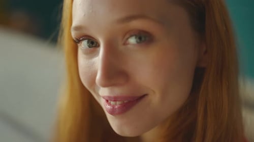 Woman With Red Hair Smiling in Natural Light
