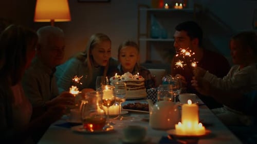 Family Celebrates Birthday with Sparklers and Cake
