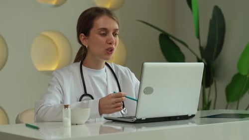 Woman Doctor on Video Call in Modern Office