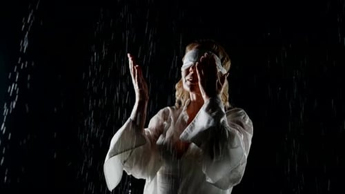 Happy Blindfolded Woman Enjoying Rain in Night Feeling Water Drops on Her Face