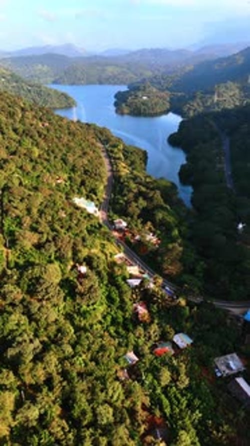 Private houses located on the green lush slopes of mountains descending into the lake.