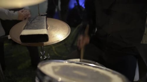 Musician playing the drums. Close up on drumsticks and drums set.