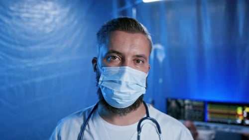 Frustrated Doctor by Patient Laying on Bed in Hospital, Coronavirus Concept