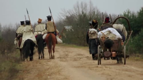 Historical reenactment of soldiers riding horses on path