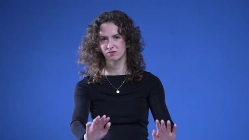 Femme repoussant avec les mains en regardant la caméra. Une femme d'une vingtaine d'années signale son refus