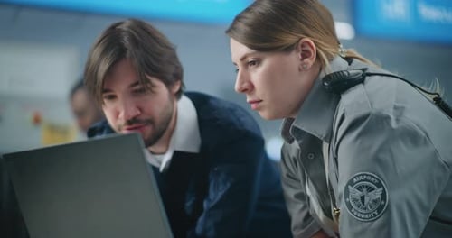 Airport Security Checkpoint Close Up of Two Diverse Security Officers Using Laptop and Talking