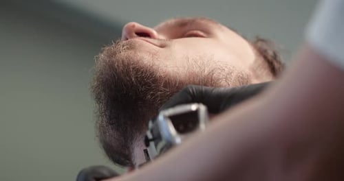 Beard Trim by Barber in Black Gloves