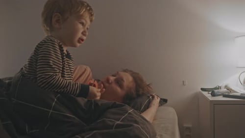 Child With Mother in Bedroom at Night