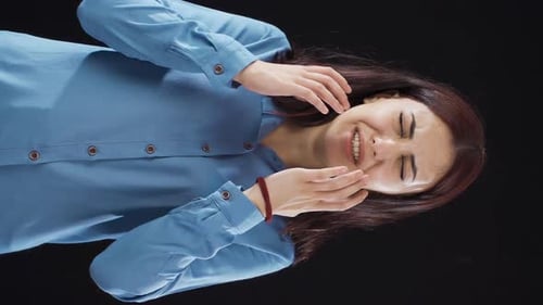 Distressed Woman Cries with Hands on Face