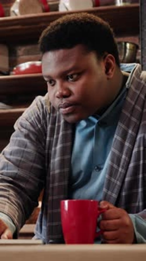 An Individual Working From the Comfort of Their Home While Casually Holding a Mug in Hand