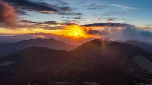 Majestic Mountain Range at Sunrise with Low Clouds