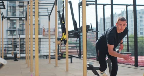 Young Man Making Jump Exercise Outdoors Male Training at Sports Ground Workout Exercises Healthy