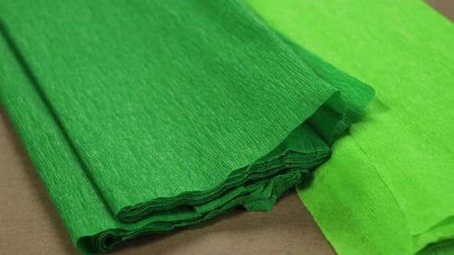 Light green and bright green crepe paper. Craft paper for making piñatas. Close up.