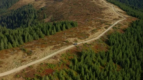 Aerial Car on Mountain Road View Going Camp Among Green Rocky Trees