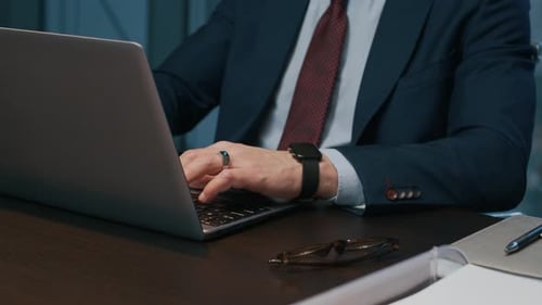 Unrecognizable Entrepreneur Doing Financial Report on Laptop
