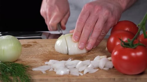 Man Dicing an Onion on Cutting Board