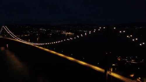 Nightime Suspension bridge drone reveal. Lit up. Aerial, Bergen, Norway. Wide span.