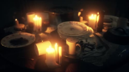Atmospheric Flickering Candles on a Dining Table