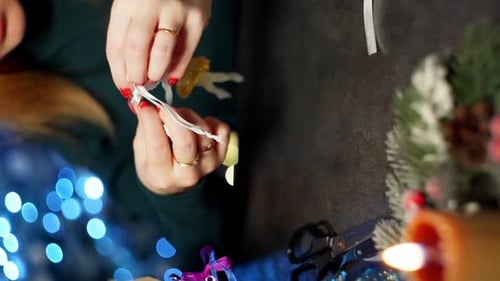 Closeup of a Woman Creating Christmas Decorations for Her Home