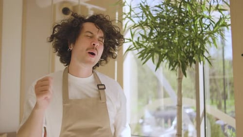 The Waiter Man Dances in a Cafe A Cafe Worker in a Good Mood Dances to Music During a Break