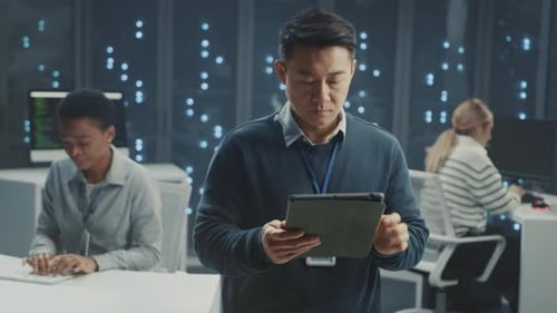 Man with Tablet in Futuristic Data Center Office