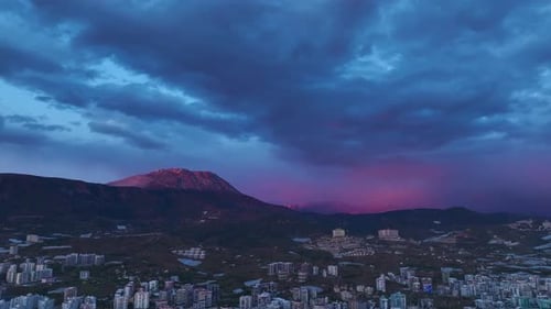Aerial Video of Vibrant Orange and Pink Sunset Clouds Casting Light Over Endless Blue Ocean Waters