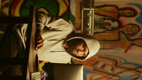 Man in Hoodie Working on Computer at Night