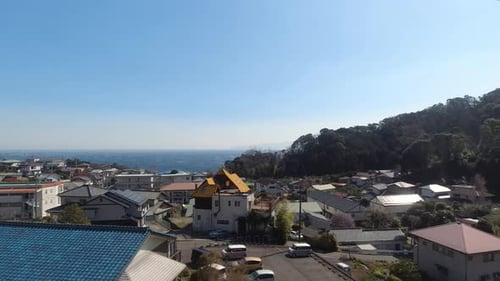 Beautiful small fishing town in Japan passing by in front of train window