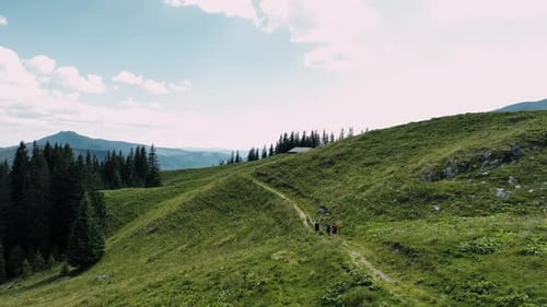 Drone View of Anonymous Male Travelers Walking on Mountain Road