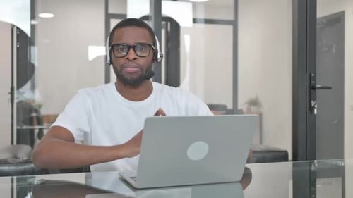 Young Adult Working at Computer in Office