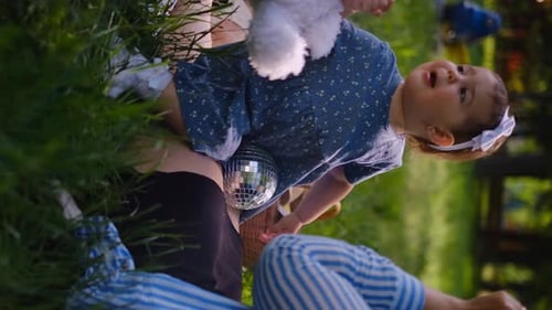 Mother and child together in the park outdoors, lying in the grass. Motherhood happiness concept. Da