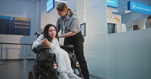 Airport Terminal Female Security Officer Inspecting Woman in Wheelchair