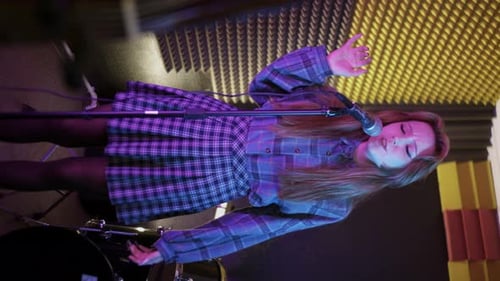 Young Pretty Woman Recording a Song in the Studio