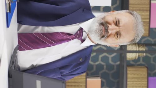 Adult in Business Suit Gestures at Desk