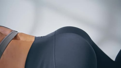 Woman Exercising Leg Raises in Home Gym