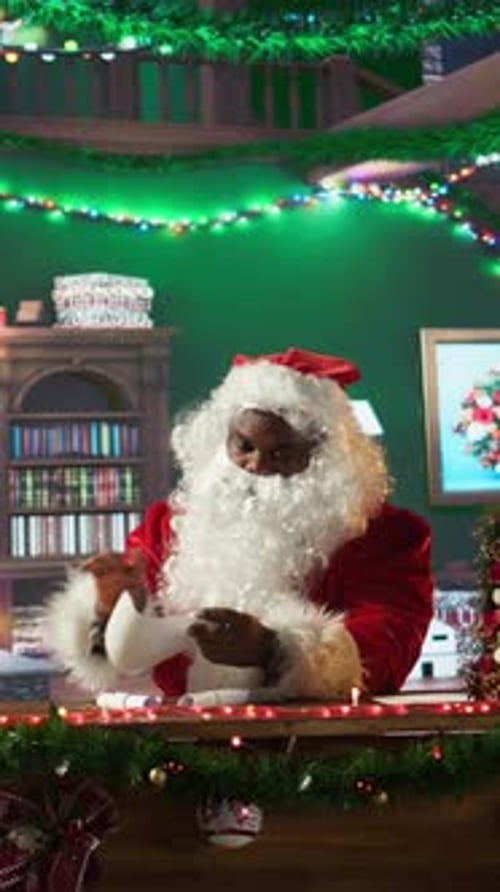 Vertical Video Father Christmas Opening His Correspondence in His Festive Workshop