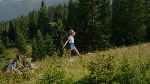 Woman Hiking Through Beautiful Mountain Scenery