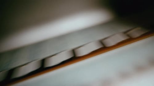 Macro Shot Of Filmstrip Rolling Through Projector Gate