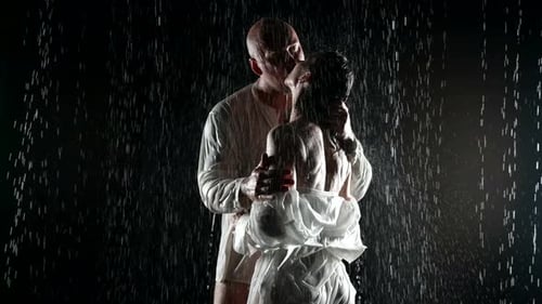 Man and Woman Embracing in the Rain at Night