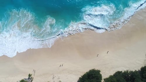 Aerial View of Turquoise Waves Crashing on Tropical Sandy Beach