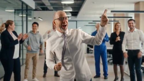 Vibrant Middle Aged Team Leader Joyously Engages In Dance Amid Office Festivities And Applause