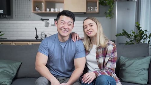 Happy Couple Video Chatting in Modern Apartment